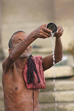 A man praying in the sacred river Ganges.