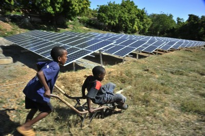 boys playing round solar panels