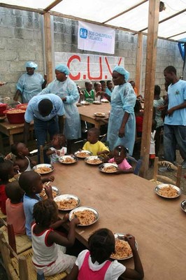 Boys and girls eating at SOS food distribution point, Port-au-Prince