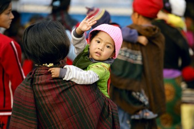 Child looking over mothers' shoulder