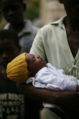 Sleeping baby held by his mother, Port-au-Prince, after the earthquake