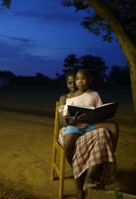 Reading a book at night, Tlokweng, Botswana