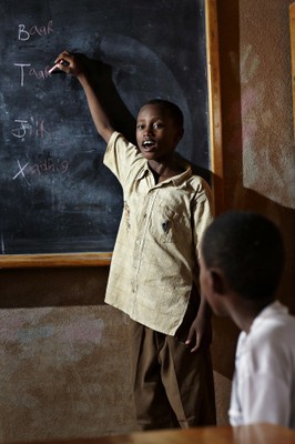 A child writing on the blackboard