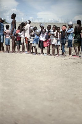 Many children waiting in line at an SOS food distribution point, Santo